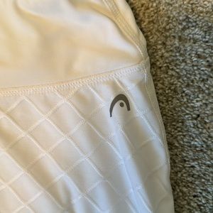 White tennis skirt and built-in shorts.  Head size large